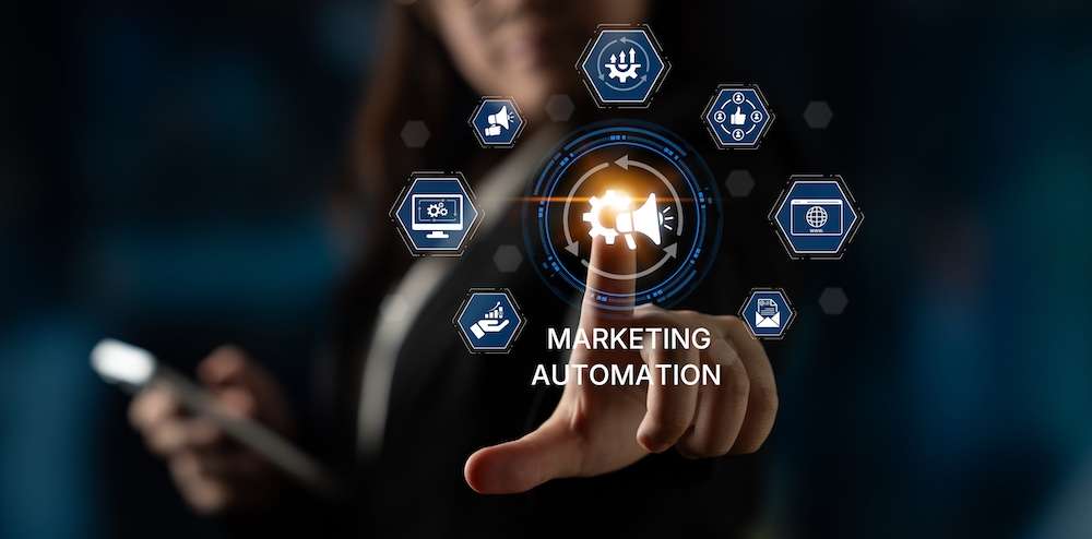 A person points at a virtual interface displaying icons related to marketing automation, including gears, graphs, and a megaphone, with the words Marketing Automation in the center.